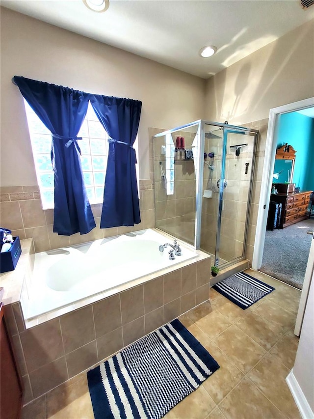 bathroom with tile patterned floors and independent shower and bath