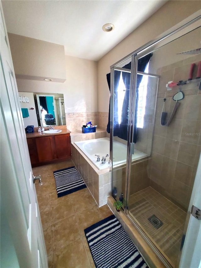 bathroom featuring vanity, tile patterned flooring, and plus walk in shower