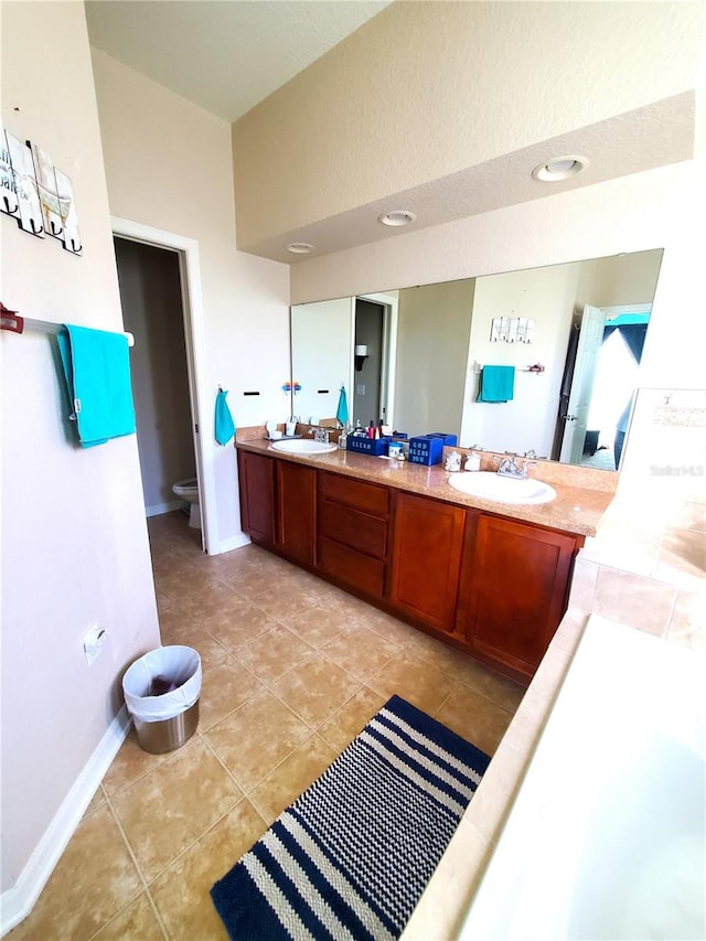 bathroom with tile patterned floors, vanity, and toilet