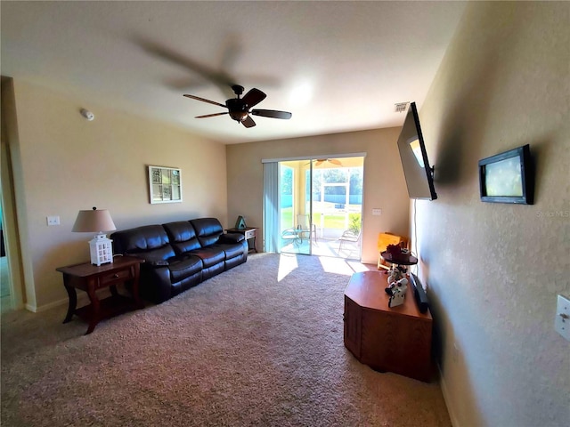 living room with ceiling fan and carpet floors