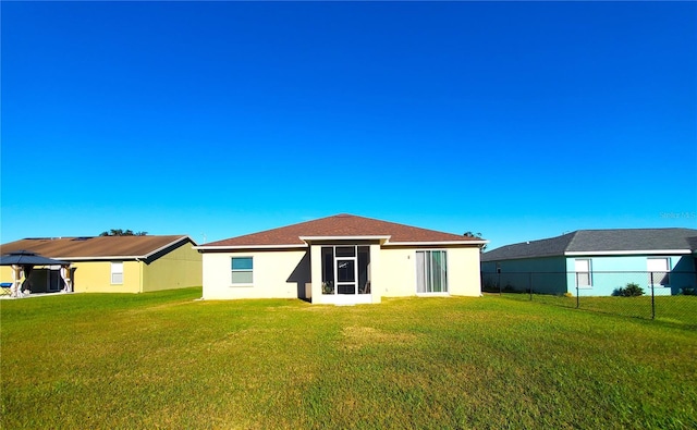 rear view of property featuring a gazebo and a lawn