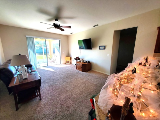 carpeted living room featuring ceiling fan