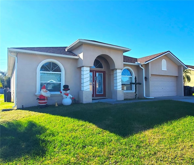 ranch-style home with a garage and a front lawn