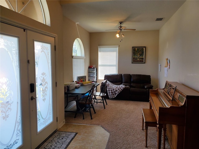 carpeted entrance foyer with french doors and ceiling fan