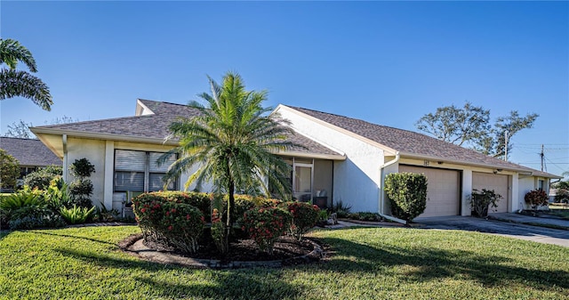 ranch-style home with a front yard and a garage