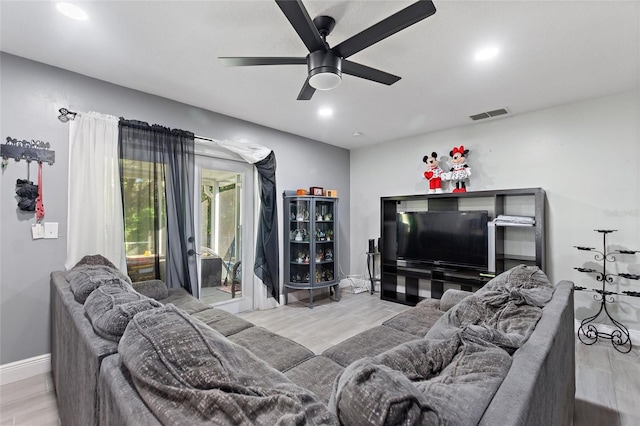 living room with ceiling fan and light wood-type flooring