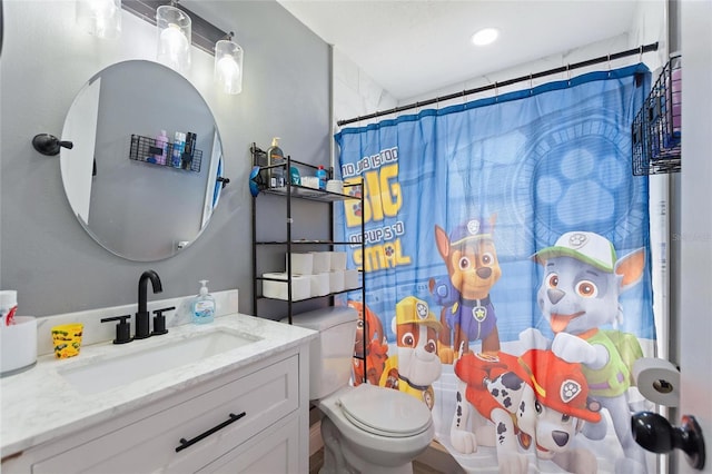 bathroom with a shower with curtain, vanity, and toilet