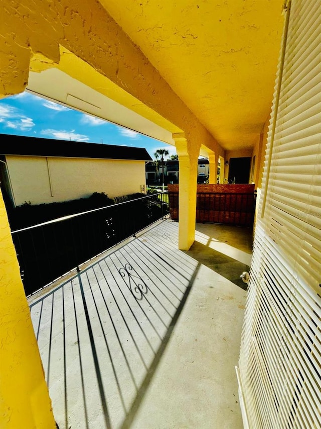 view of patio featuring a balcony