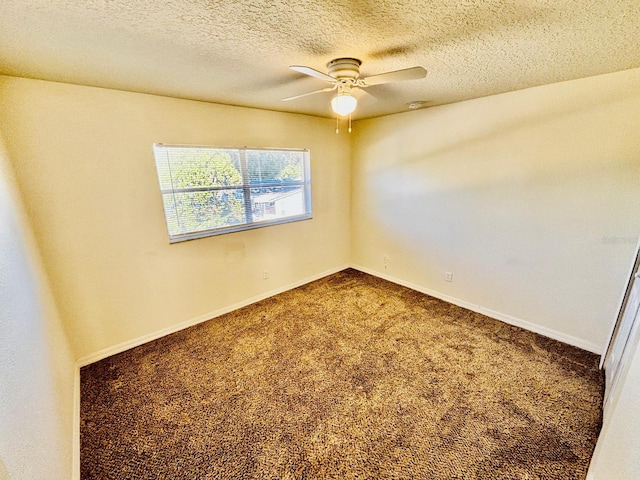 carpeted spare room featuring ceiling fan and a textured ceiling