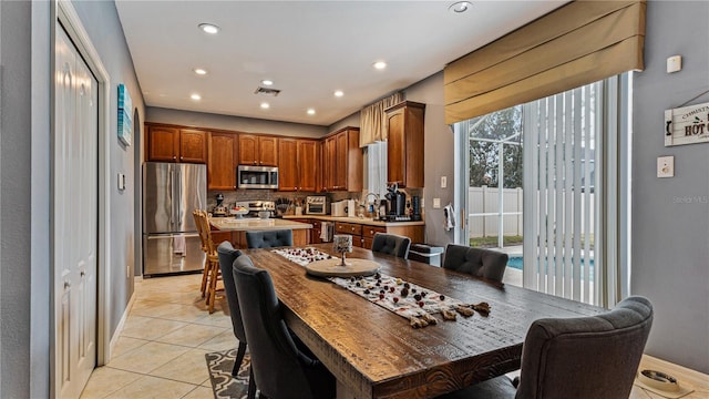 tiled dining room with sink