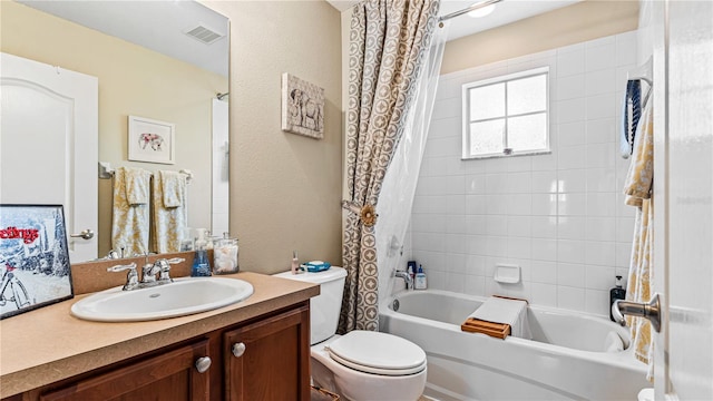 full bathroom featuring shower / bath combination with curtain, vanity, and toilet