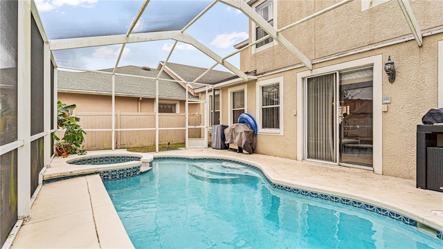 view of swimming pool featuring an in ground hot tub, a lanai, and a patio area