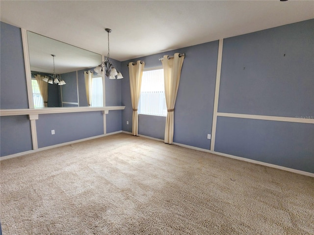 unfurnished room featuring an inviting chandelier and carpet