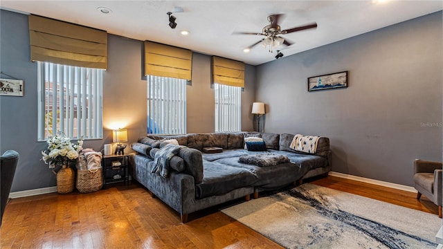 living room featuring hardwood / wood-style flooring and ceiling fan