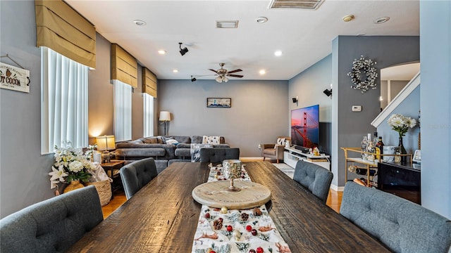 dining space with ceiling fan and wood-type flooring