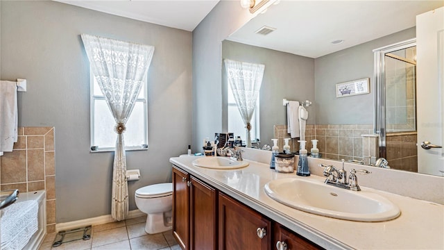 bathroom featuring an enclosed shower, vanity, tile patterned floors, and toilet