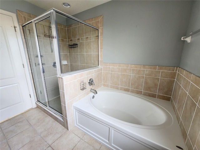 bathroom featuring tile patterned flooring and separate shower and tub