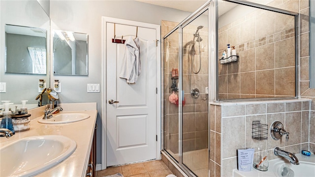 bathroom with tile patterned flooring, vanity, and walk in shower