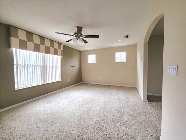 spare room featuring ceiling fan and carpet flooring