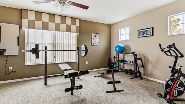 exercise room with ceiling fan and light carpet