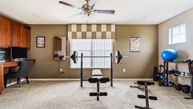 exercise room with light carpet and ceiling fan