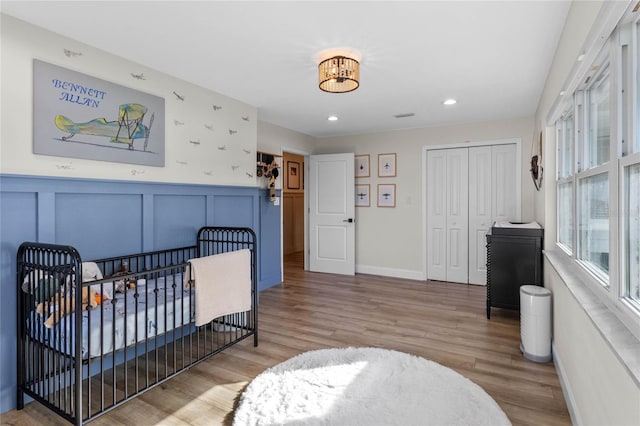 bedroom with a closet and light hardwood / wood-style flooring