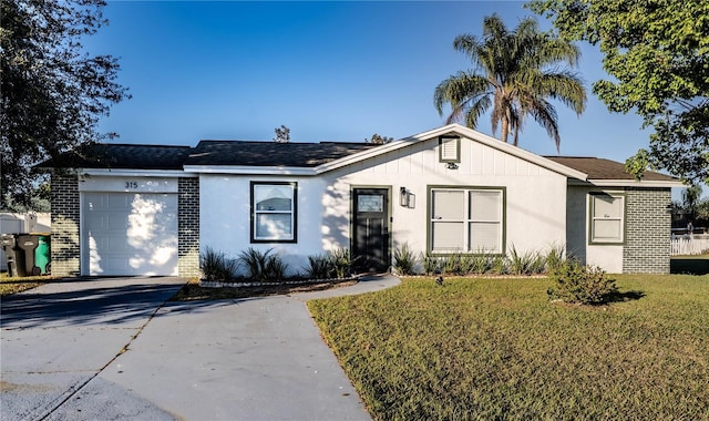 ranch-style home featuring a front lawn and a garage