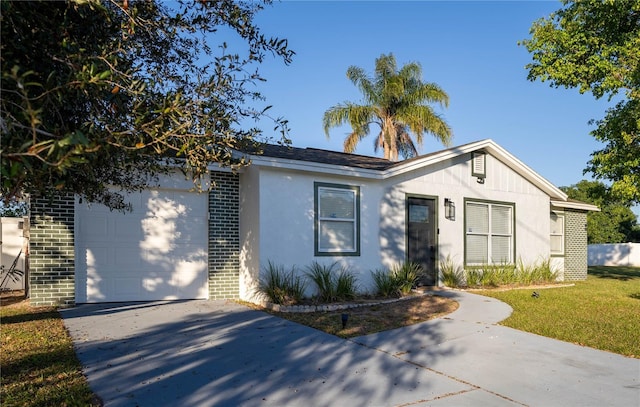 view of front of property featuring a garage and a front lawn