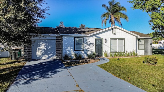 ranch-style home with a front lawn and a garage