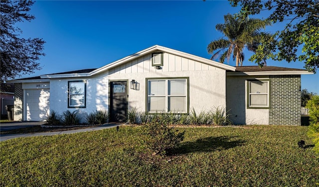 view of front of property with a front yard and a garage