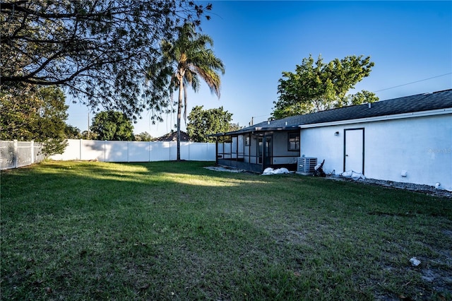 view of yard with a sunroom and cooling unit