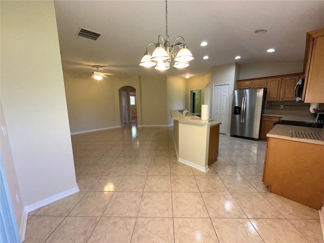 kitchen featuring a center island, hanging light fixtures, light tile patterned floors, ceiling fan with notable chandelier, and appliances with stainless steel finishes