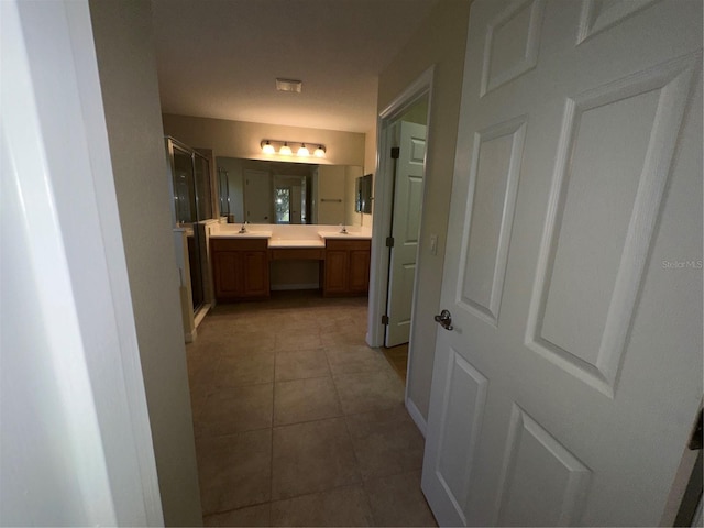 bathroom with tile patterned floors, vanity, and an enclosed shower