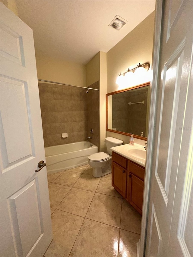 full bathroom featuring tile patterned flooring, vanity, toilet, and tiled shower / bath