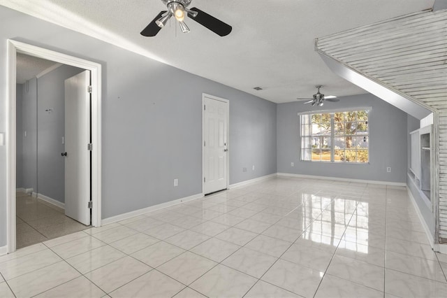 tiled spare room featuring ceiling fan and a textured ceiling