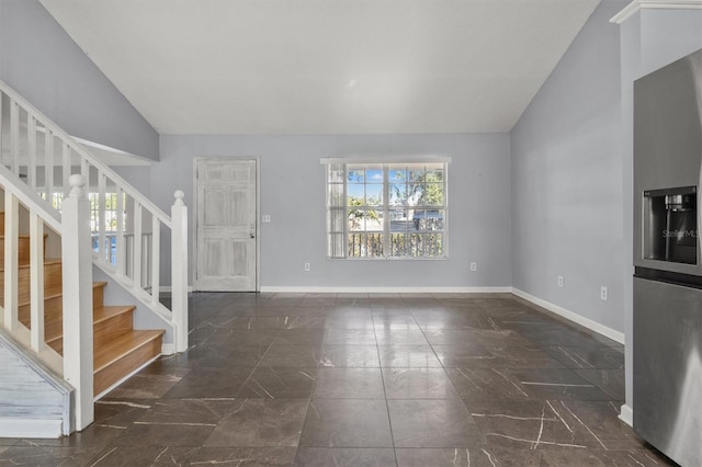 unfurnished living room with vaulted ceiling