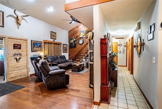 corridor featuring wood walls and light hardwood / wood-style flooring