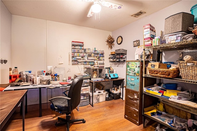 office area with ceiling fan, a textured ceiling, and hardwood / wood-style flooring