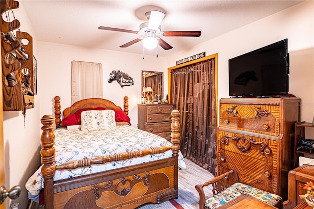 bedroom with wood-type flooring and ceiling fan