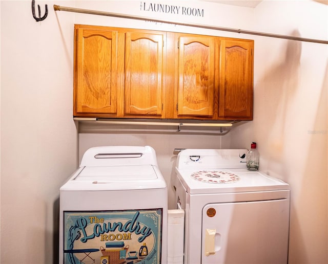 laundry room featuring cabinets and washing machine and dryer