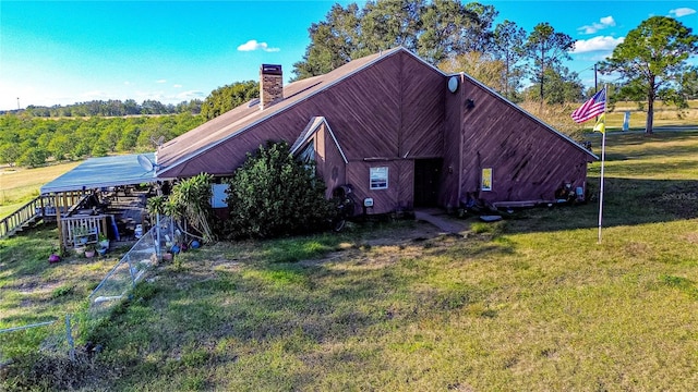 rear view of property featuring a yard