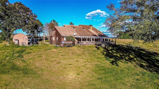 back of house with an outbuilding