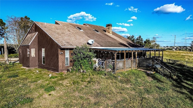 rear view of property with a lawn