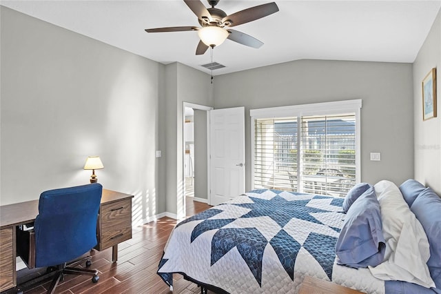 bedroom featuring visible vents, a ceiling fan, vaulted ceiling, wood finished floors, and baseboards