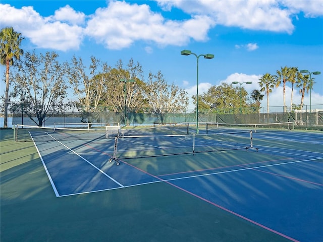 view of tennis court featuring fence