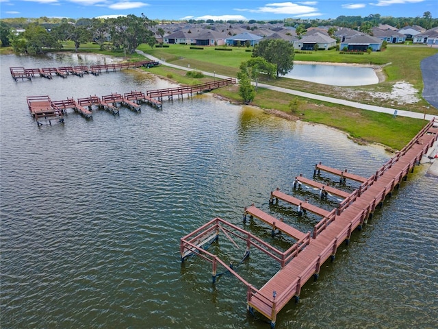 drone / aerial view featuring a residential view and a water view