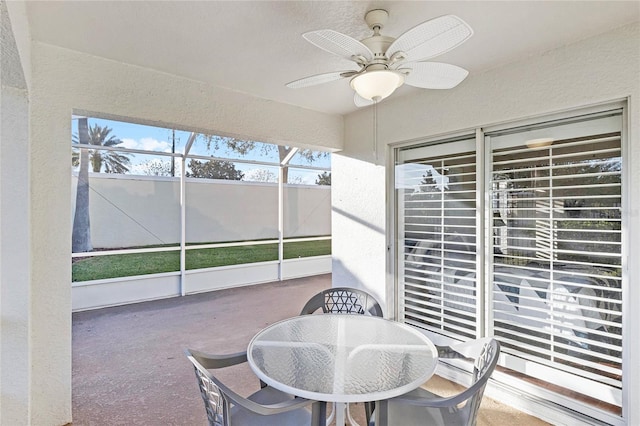 sunroom with a ceiling fan