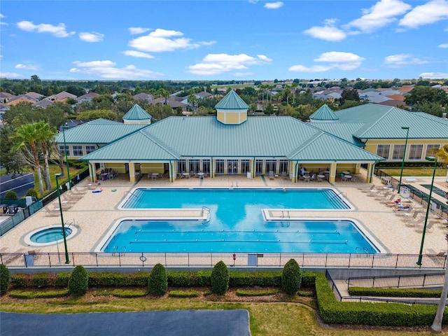 pool with a patio area, a hot tub, fence, and a gazebo