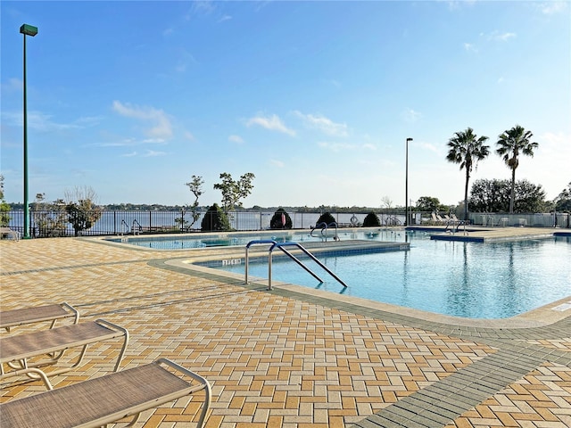 pool featuring fence and a patio