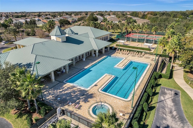 community pool featuring a patio and a hot tub